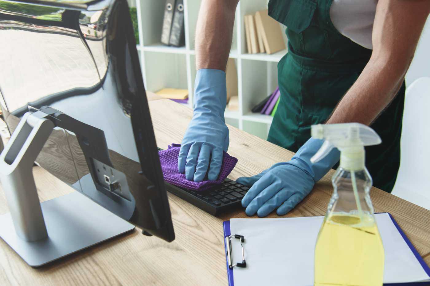 Man Cleaning Computer Keyboard