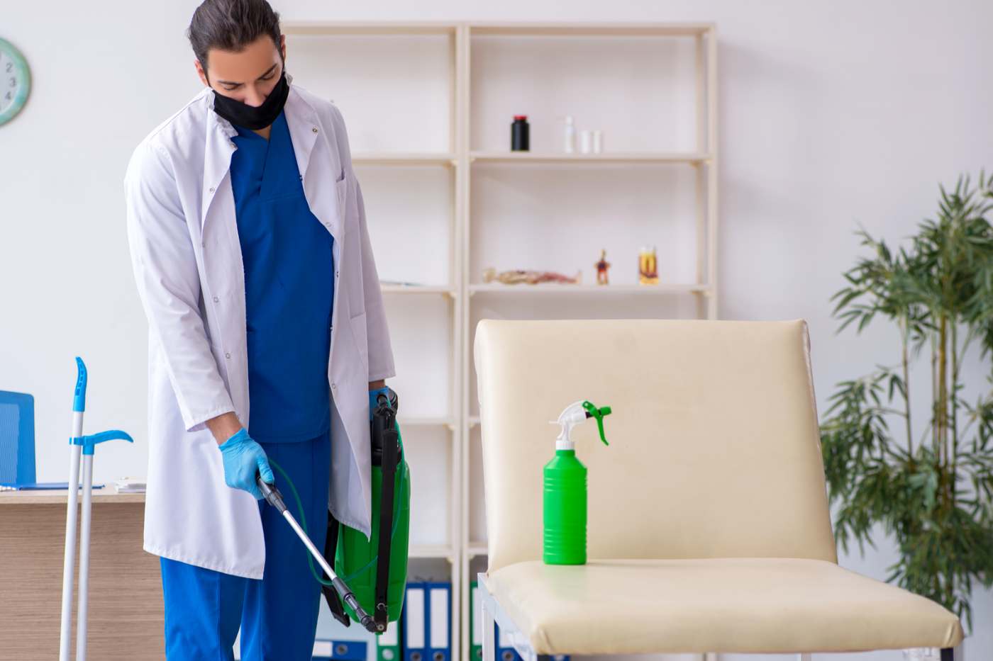 Man Disinfecting Clinic Office During Pandemic Man Disinfecting Clinic Office During Pandemic