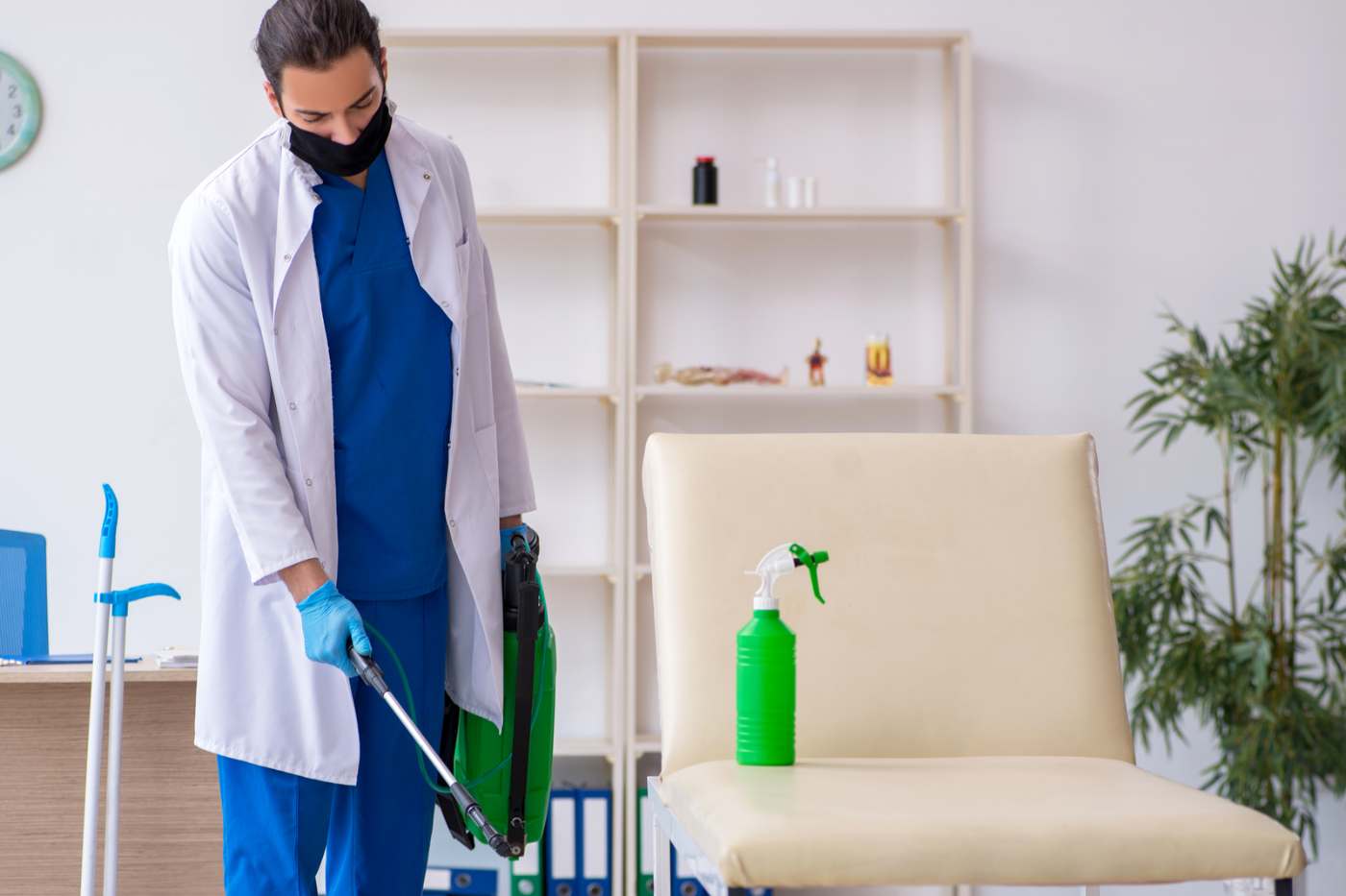 Man Disinfecting Clinic Office During Pandemic