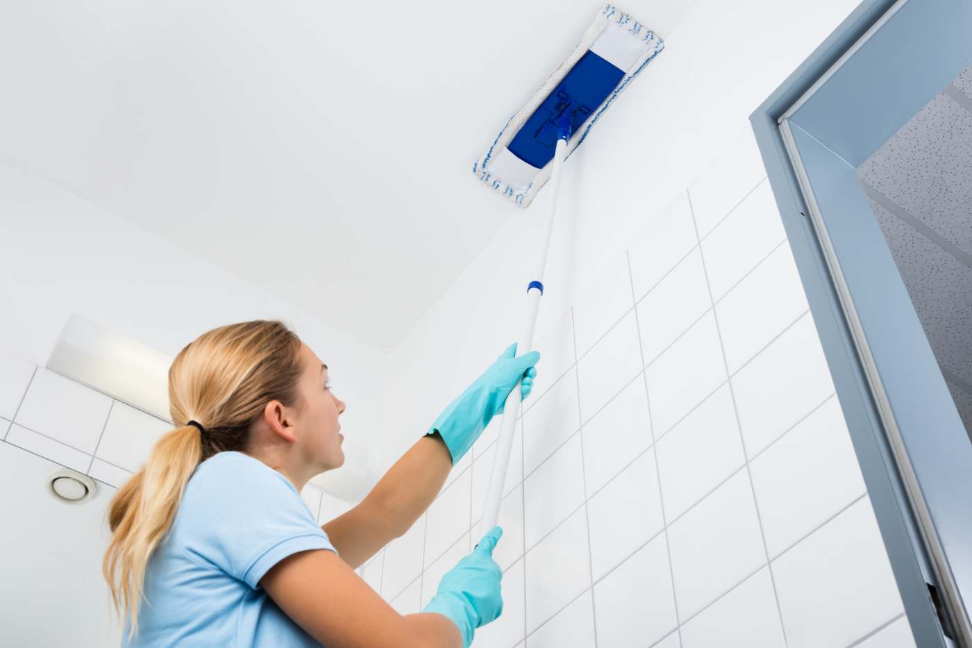 Woman Cleaning Ceiling