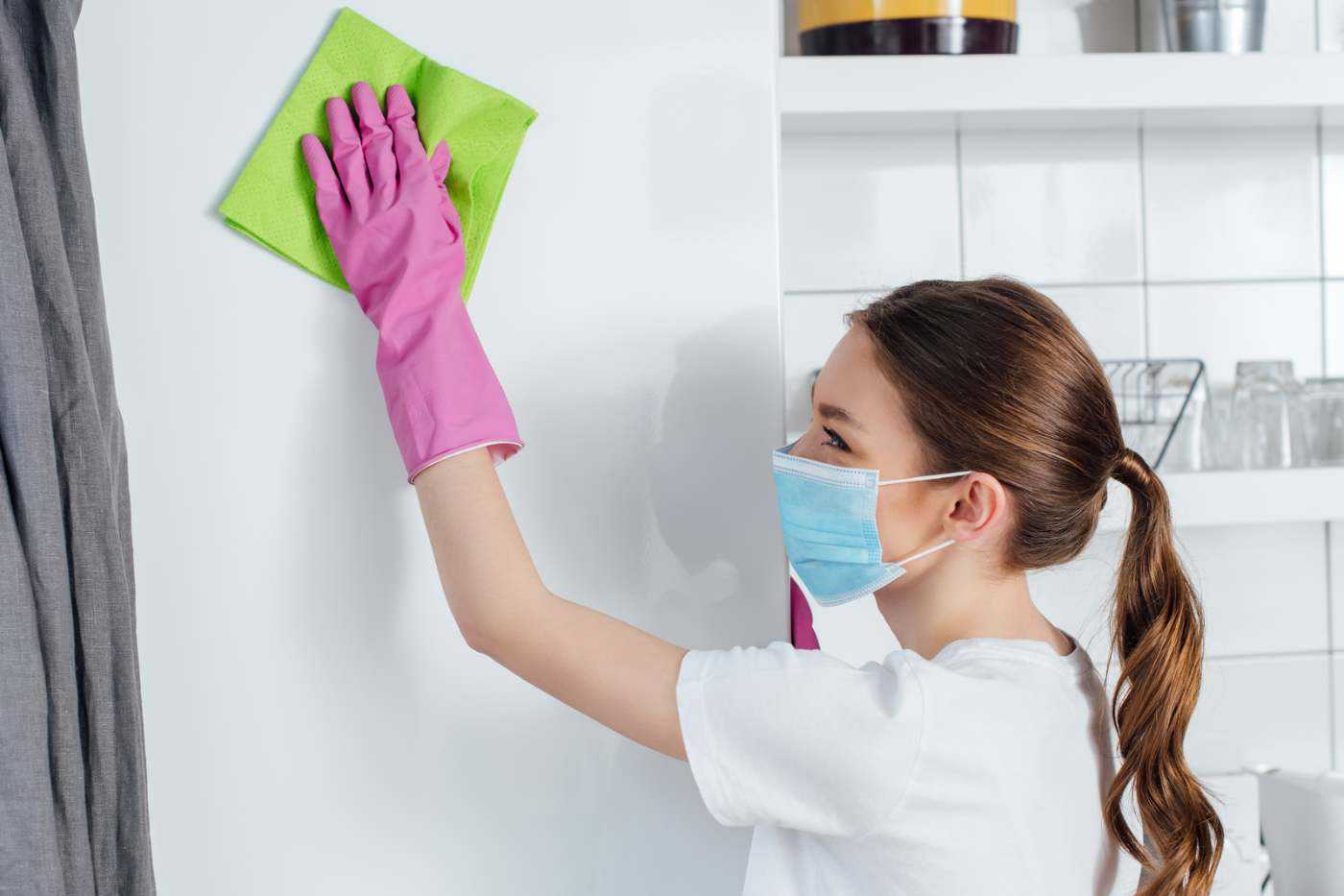 Woman Cleaning Walls In Medical Facility